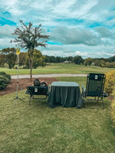 Picture of a client receiving a mobile IV on a golf course.